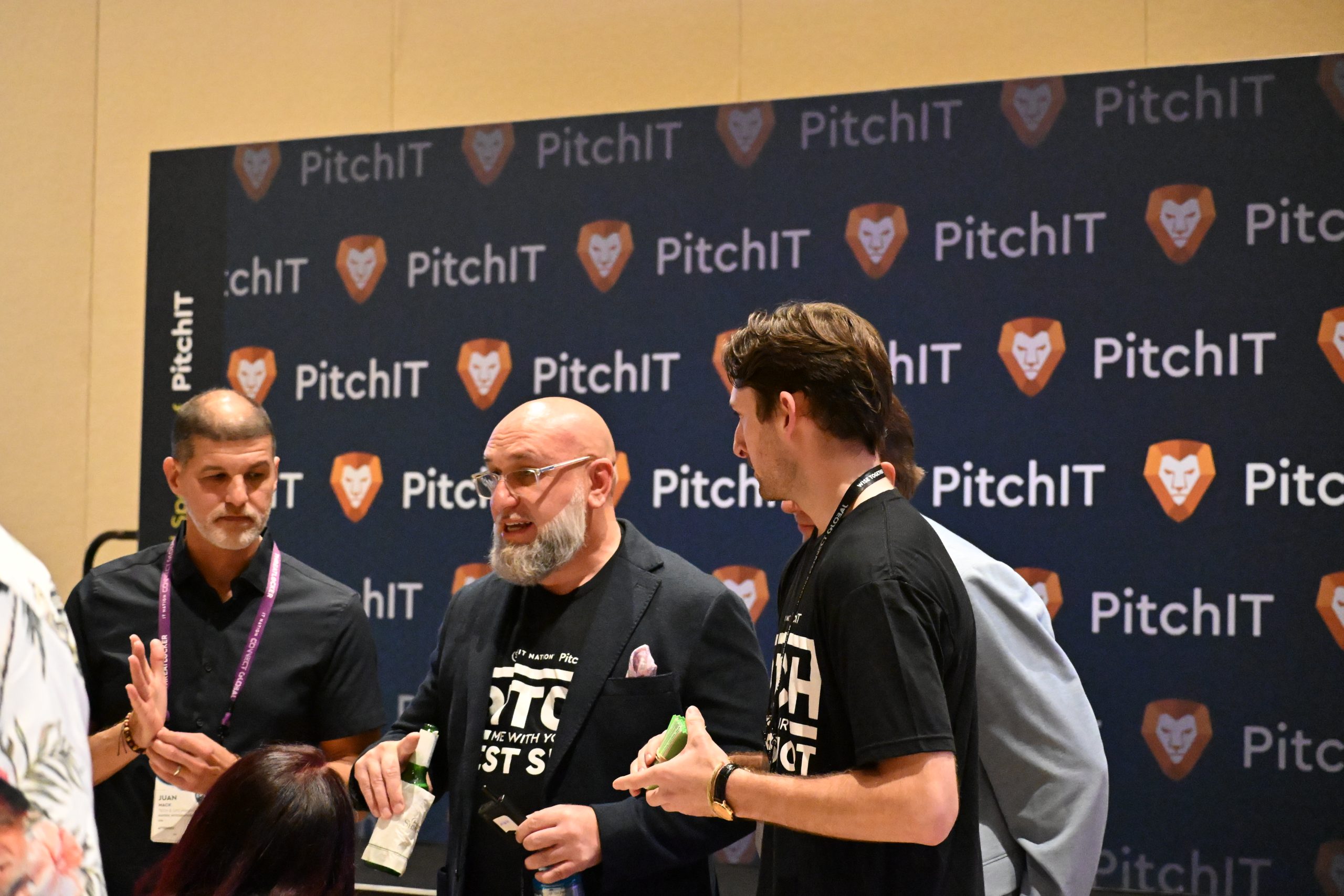 PitchIT networking in front of event backdrop
